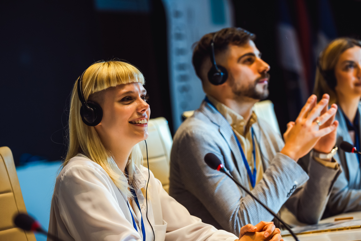 Professional interpreter providing real-time translation services for a multilingual business conference