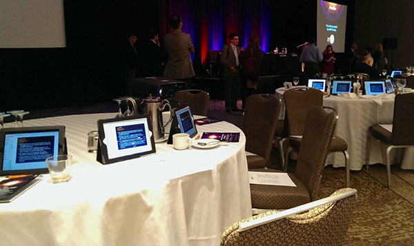 Corporate Event Rentals iPads set up on circular tables at an event