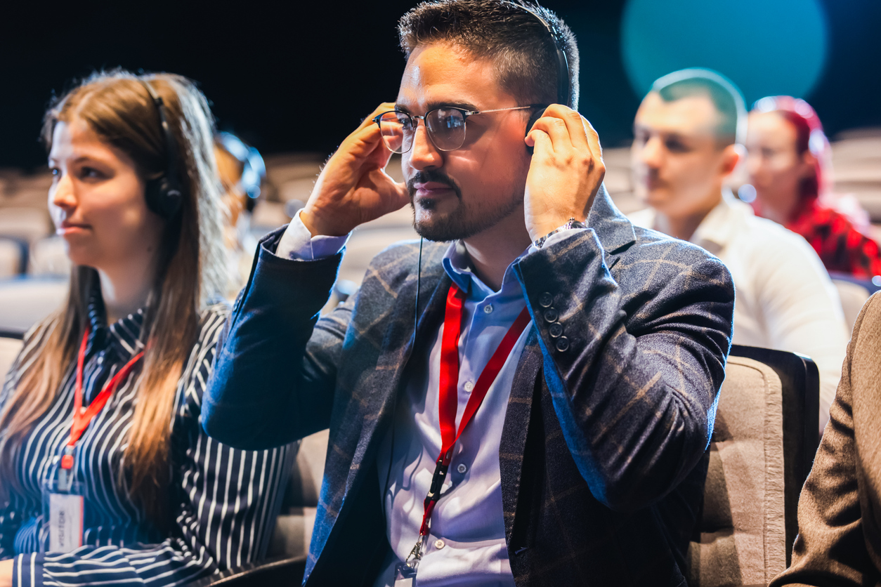 Large multilingual conference audience using interpretation services and translation headsets