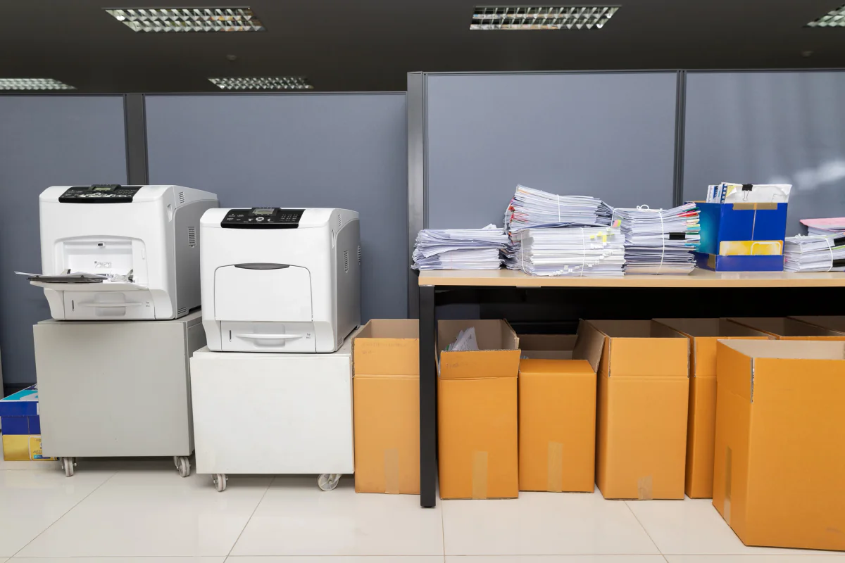Event operations area with printers producing conference materials, badges, and registration documents