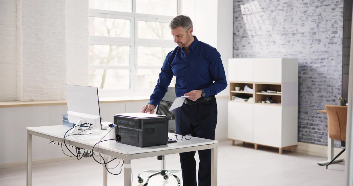 Temporary office setup with printers and workstations supporting short-term business operations
