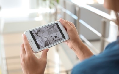 Man looking at security camera footage on his smartphone