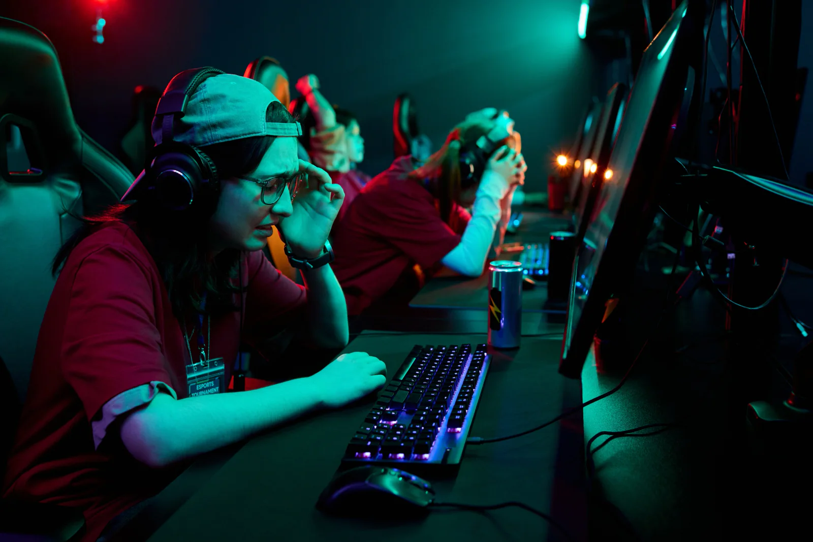 Esports finals production setup with caster desk, gaming stations, monitors, and live event broadcast support