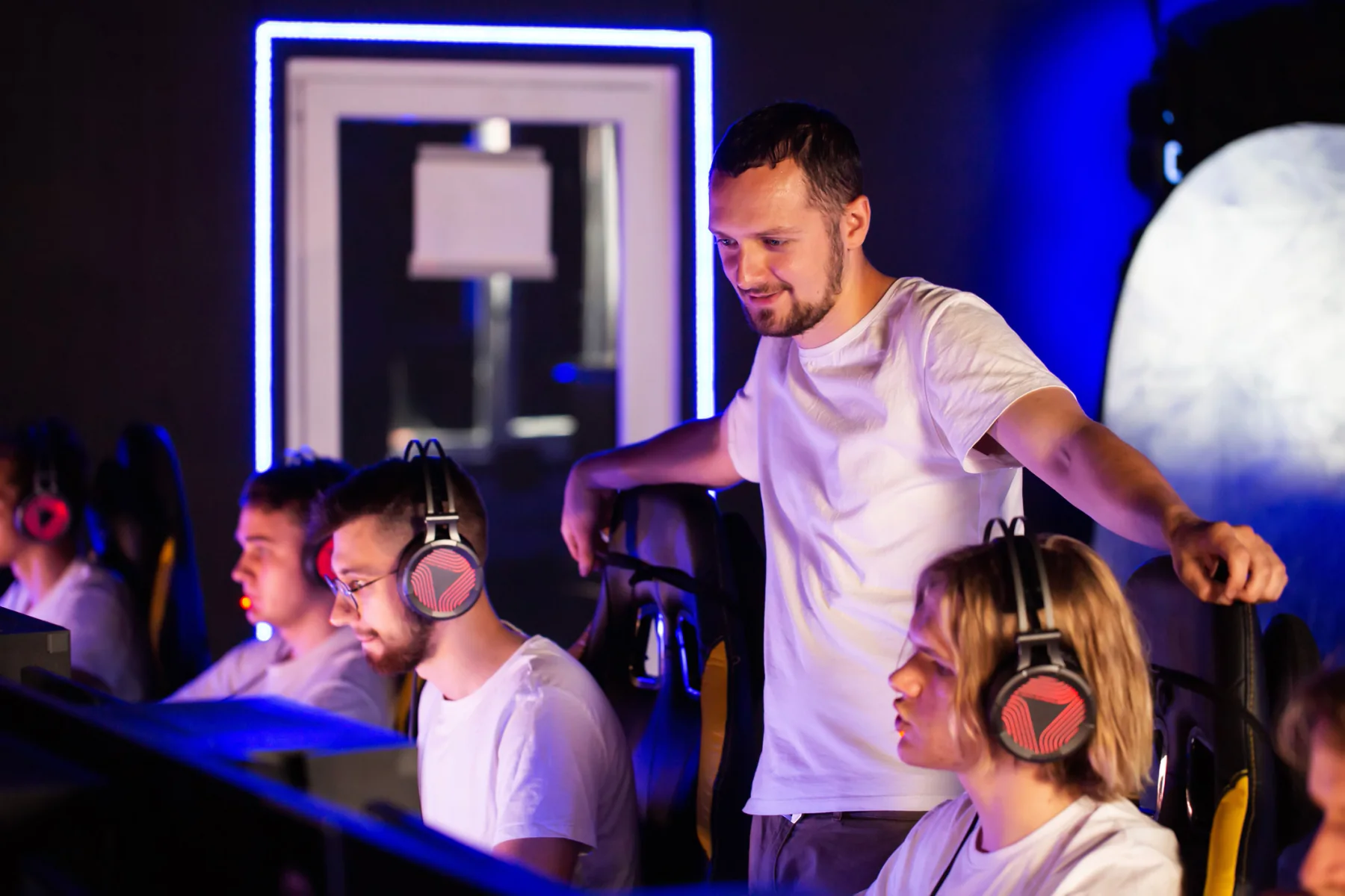 Esports event with gaming stations, monitors, players, and tournament technology