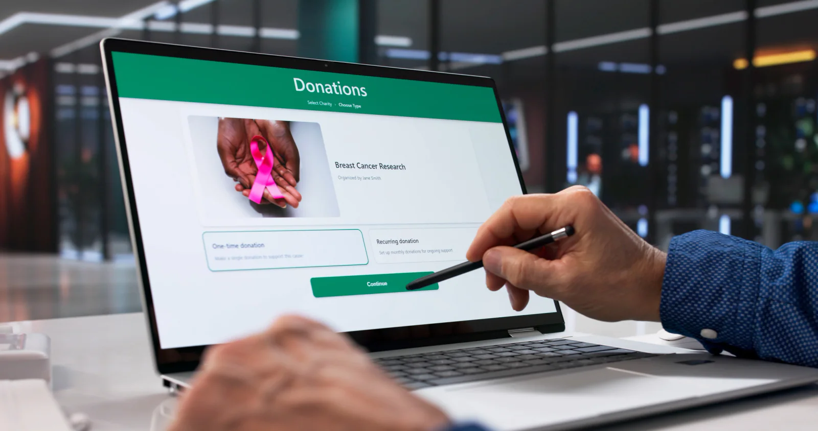Fundraising auction and donor engagement station with tablets, branded signage, and guests participating in an event activity