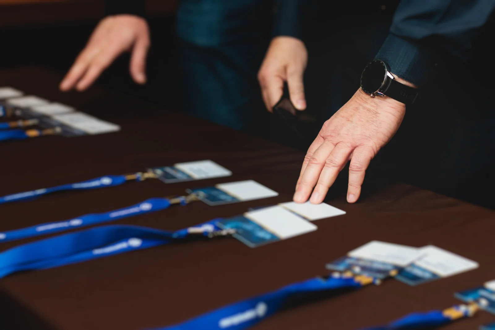 Silent auction and donor engagement station with tablets, event signage, and guests participating in a nonprofit fundraiser
