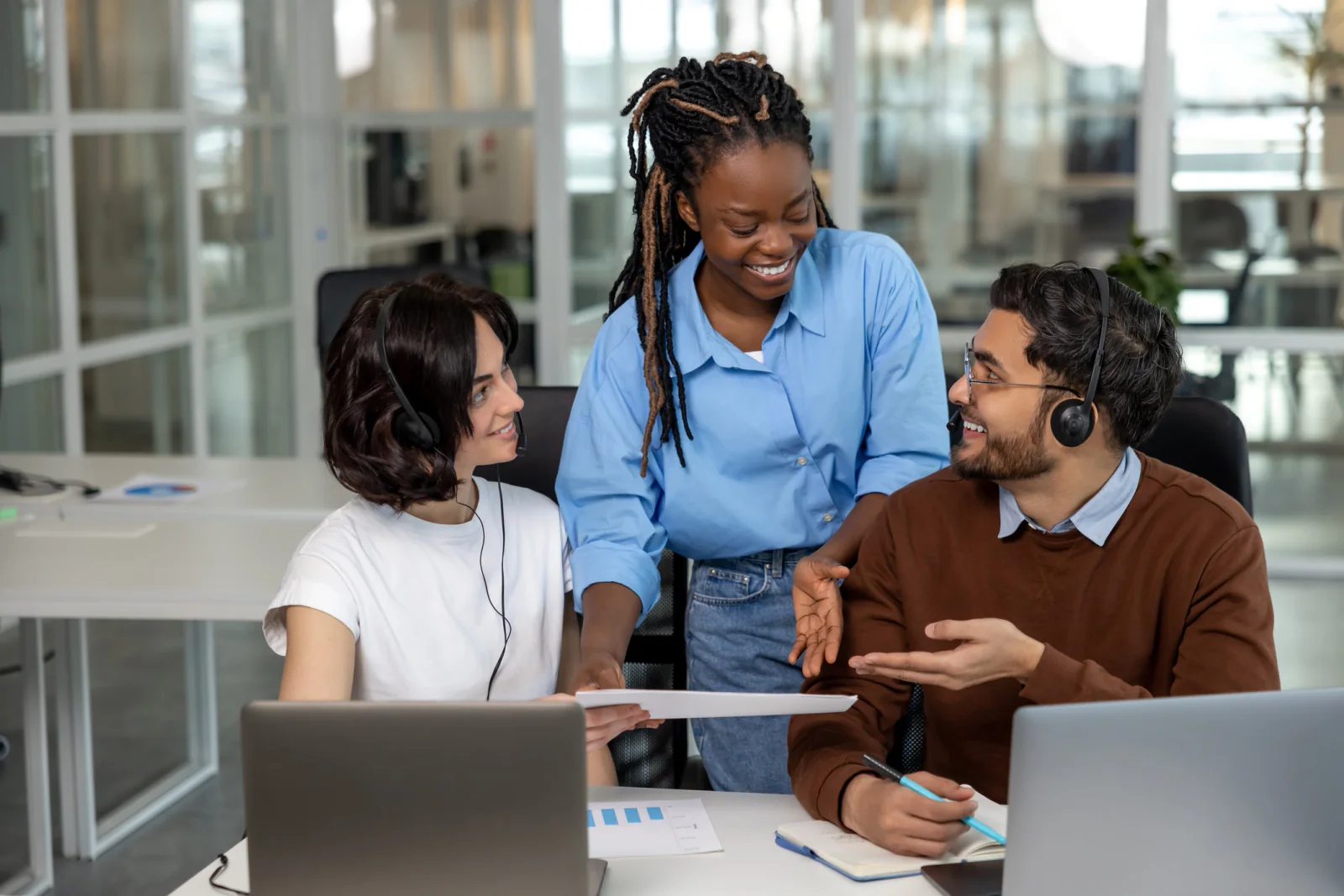 Business team managing communication continuity during an office move or transition using laptops and headsets