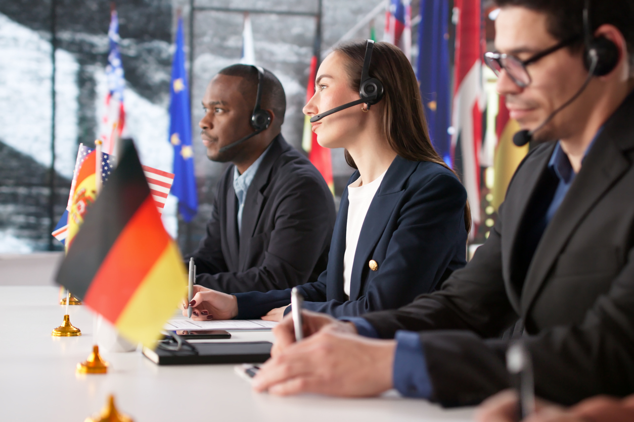 Conference attendees listening to simultaneous interpretation through wireless headsets
