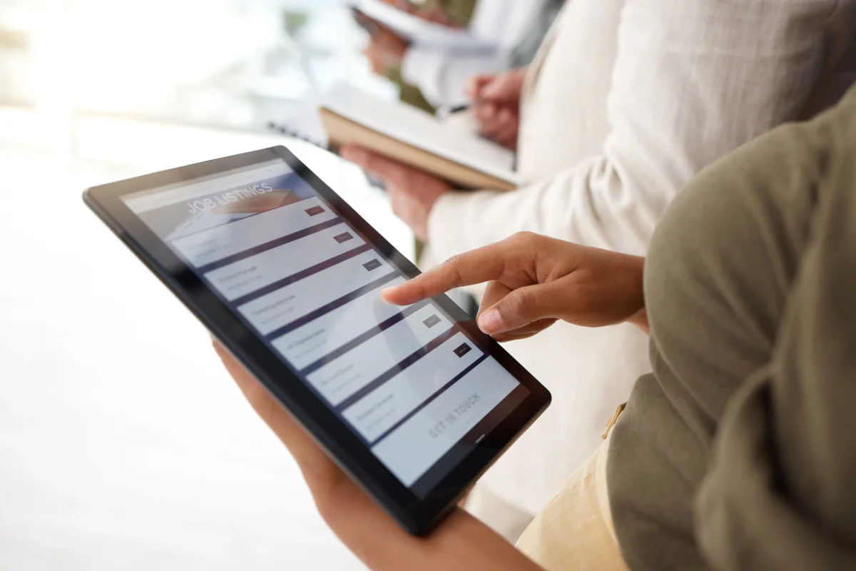 Staff member using a tablet POS setup at an event booth for payments, transactions, and concessions