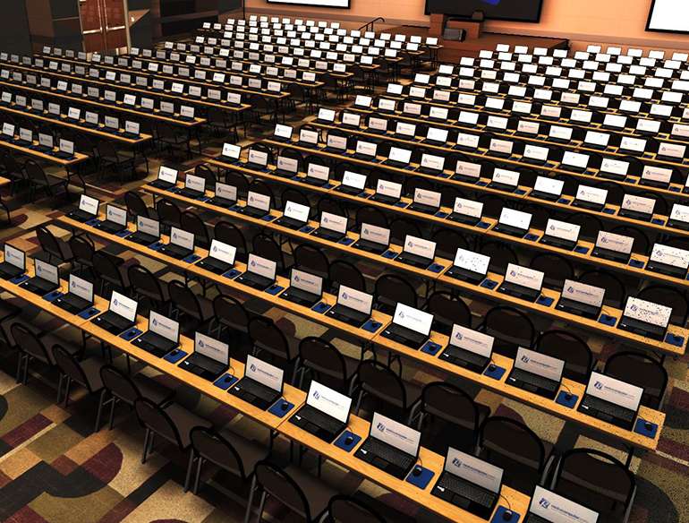 A large auditorium with hundreds of laptops ready for use