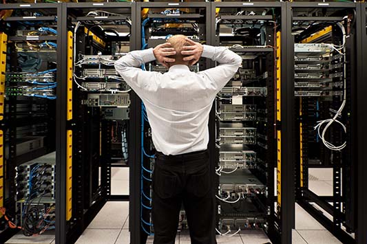 Person Standing In Front Of Servers